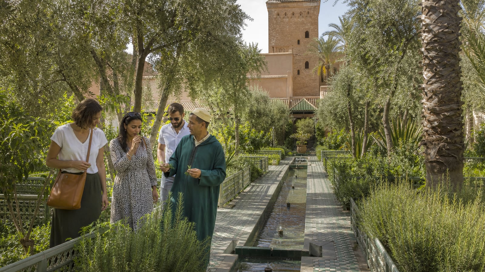 Travellers discovering fragrant herbs with a guide in Le Jardin Secret